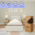 8-inch cooling comfort twin mattress in a box beside an unboxed twin mattress on an upholstered bed in a pastel-striped children's bedroom with wooden nightstands and lamps