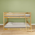 Natural wood bunk bed with ladder, twin mattresses and pillows in a minimalist kids' bedroom with green wall and hardwood floor, space-saving design