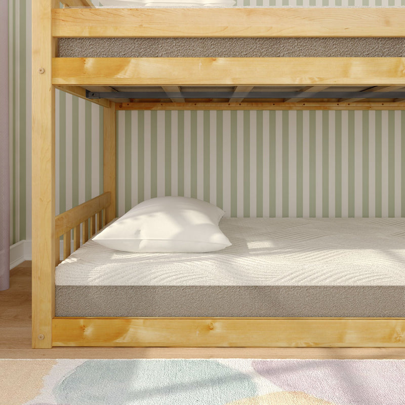 Wooden bunk bed with comfortable mattresses and pillows in a cozy bedroom setting.