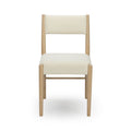 Front view of modern Scandinavian dining chair with cream bouclé upholstery, cushioned seat and back, light oak frame and tapered legs on white background