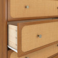 Mid-century modern wooden dresser with woven rattan cane drawer fronts, round brass knobs, and a partially open drawer revealing light wood interior and metal drawer slide