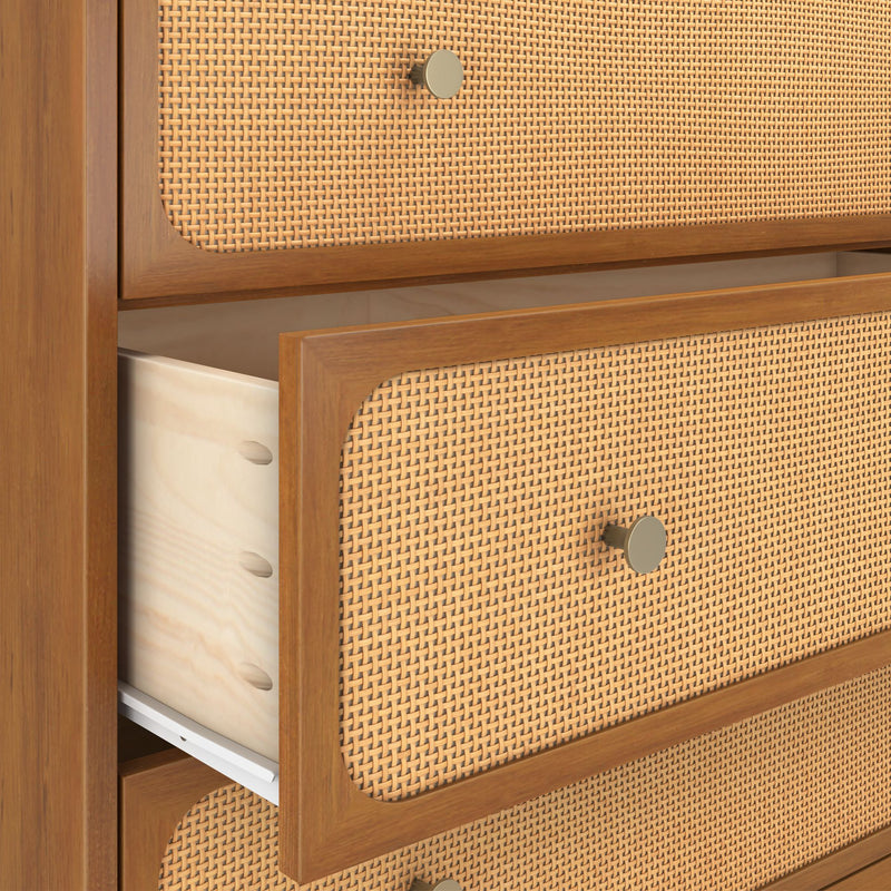 Mid-century modern wooden dresser with woven rattan cane drawer fronts and brass knobs, open drawer showing light wood interior
