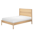 Light oak platform bed with woven rattan headboard and white mattress, minimalist Scandinavian-style bedroom furniture