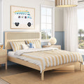 Coastal kids bedroom with light wood bed, rattan headboard, yellow striped bedding, surf-van wall art and palm-tree window view