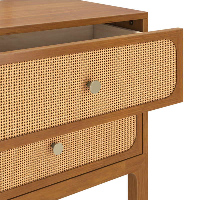 Mid-century modern wooden bedside table with woven rattan cane drawer fronts, brass round knobs, warm wood finish and open top drawer