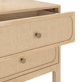 Light wood mid-century modern nightstand with woven cane drawer fronts and brass knobs