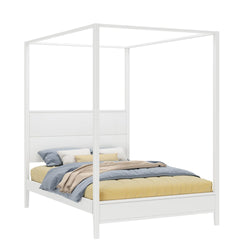 Four-poster bed with white canopy frame and cozy bedding featuring pastel pillows and blankets.
