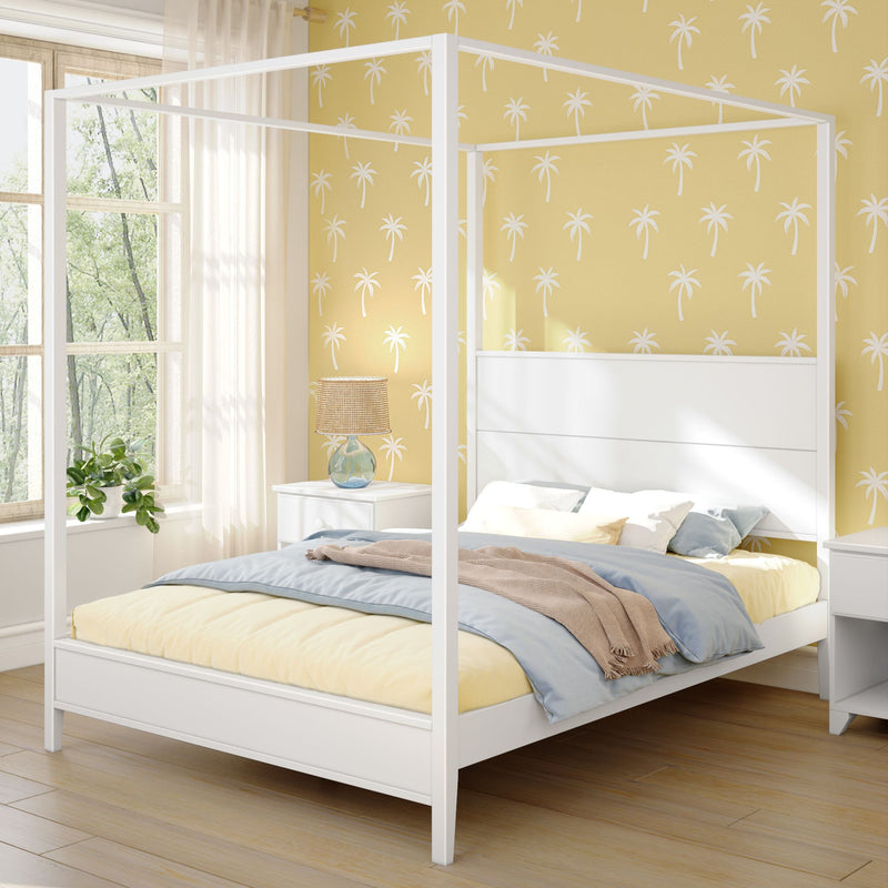 Modern bedroom with a white canopy bed, yellow bedding, and tropical wallpaper design.