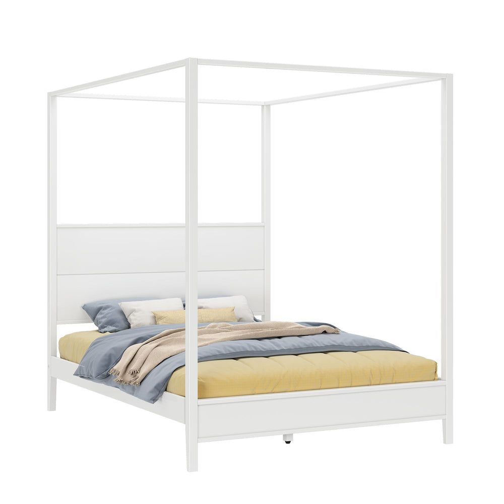 White canopy bed with luxurious pillows and soft blankets.