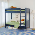 Modern kids bedroom with navy blue bunk bed and green bedding, teddy bear on top, plush chair, "Cool Kids Live Here" wall sign and blue striped rug