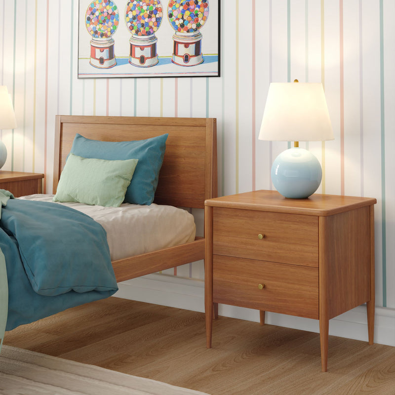 Mid-century modern wooden bed and two-drawer nightstand with blue ceramic lamp, teal bedding, pastel striped wallpaper and gumball artwork in kids' bedroom