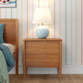 Mid-century modern wooden bedside table nightstand with two drawers and blue ceramic lamp with white shade on hardwood floor, pastel vertical striped wallpaper and teal bedding bedroom decor