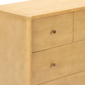 Natural light maple wood three-drawer dresser with rounded corner and brass knob pulls, modern bedroom storage