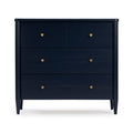 Navy blue mid-century modern three-drawer wooden dresser with round brass knobs and tapered legs for bedroom storage