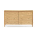 Mid-century modern six-drawer natural wood dresser with tapered legs and round brass knobs, bedroom storage