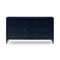 Navy blue six-drawer wooden dresser with round brass knobs and tapered legs, mid-century modern bedroom storage