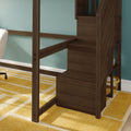 Dark walnut loft bed with built-in stairs and storage shelves against a teal wall, yellow geometric rug and partial white chair