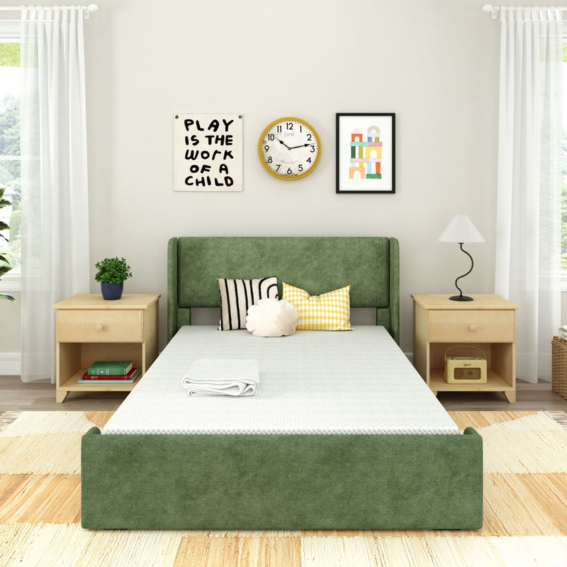 Minimalist Scandinavian-style bedroom with green upholstered platform bed, light wood nightstands, decorative pillows, wall art, clock and sheer curtains letting in natural light