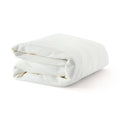 Folded white waffle-weave cotton bath towel on white background — soft, absorbent luxury towel for bathroom, spa, or guest use