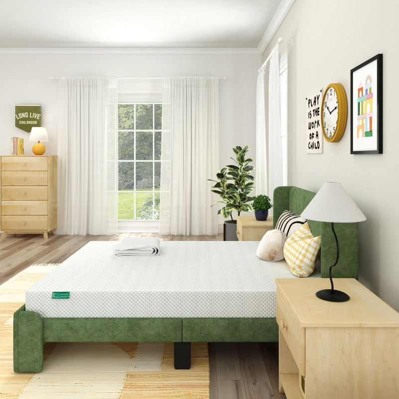 Modern bedroom with a green bed frame, white mattress, wooden nightstands, plants, and wall art for a cozy and stylish decor.