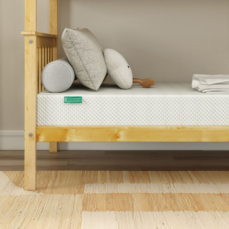 8-inch gel memory foam mattress on light wood platform bed with neutral pillows, bolster, and beige area rug