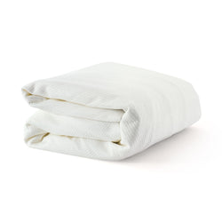 Folded white blanket on a white background.