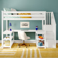 Modern white loft bed with built-in L-shaped desk, storage stairs and shelves in kids bedroom with teal wall, white swivel chair, blue desk lamp, toys and yellow rug