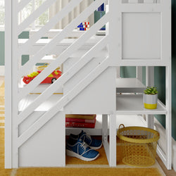 White kids' loft bed with diagonal slat guardrail, under-bed storage with blue sneakers, yellow wire laundry basket, succulent and toys in a bright bedroom