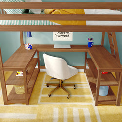 Wooden loft bed with integrated L-shaped desk workspace, white swivel chair, closed laptop, pen cup and Rubik's cube on desk, yellow geometric rug and striped bedding in a modern kids' bedroom with teal wall