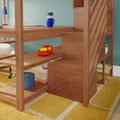 Wooden loft bed with built-in desk and staircase featuring a blue mug of colored pens, laptop and blue desk lamp on shelves, red toy car on a stair shelf and yellow patterned rug in a modern children's bedroom study nook