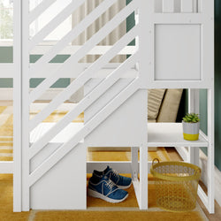 Modern white loft bed with built-in diagonal stairs and storage cubbies, blue sneakers, yellow wire basket and potted succulent in kids bedroom with green accent wall and yellow rug