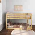 Light natural wood bunk bed with ladder in minimalist kids' bedroom, neutral pink gingham bedding, plush pillows, round rug and framed daisy wall art