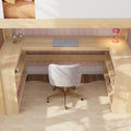 Cozy small home office nook under loft bed with light wood U-shaped built-in desk, white swivel chair, closed laptop, pink desk lamp and headphones