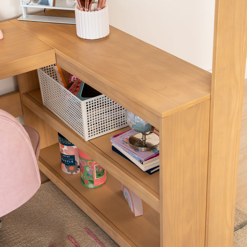Light wood desk shelving with white plastic storage basket, globe, children's books and puzzles, pink makeup brush holder and organized home office accessories