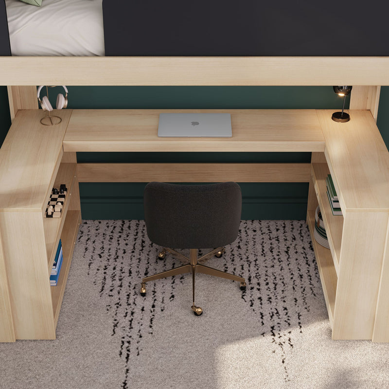 Compact home office under loft bed with built-in light wood desk, closed laptop, headphones on stand, desk lamp, ergonomic chair and storage shelves