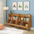 Children's room nursery with mid-century wooden toy organizer shelves filled with books and plush toys, blue accent wall with framed animal car prints, floor lamp, orange pouf and white rug on hardwood floor