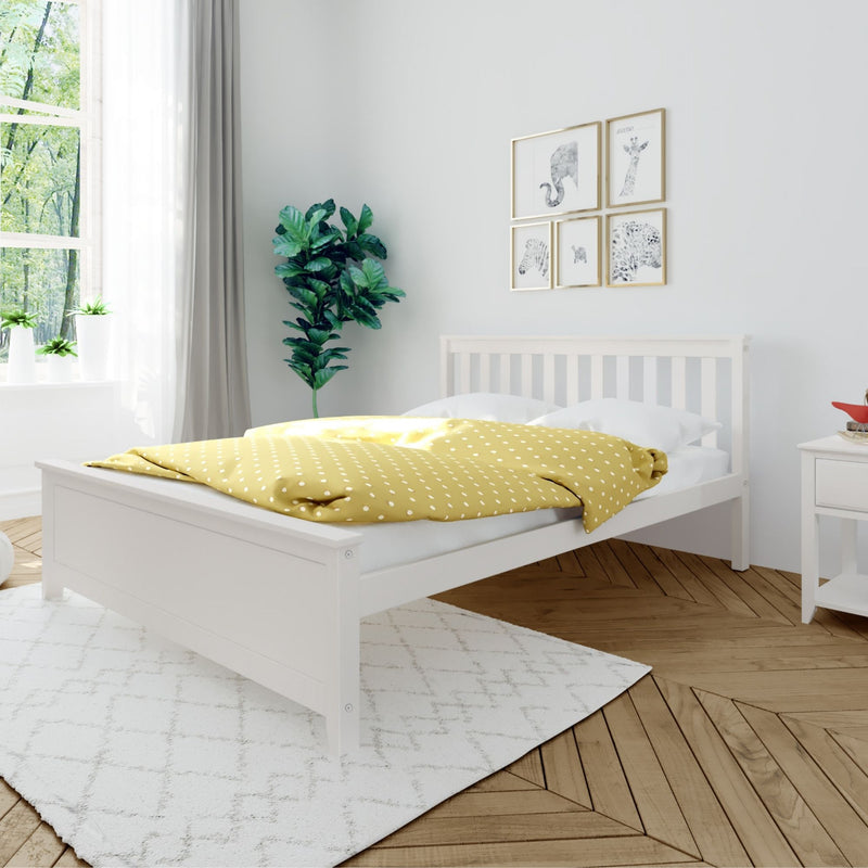 Modern minimalist bedroom with white wooden bed frame, yellow polka-dot duvet, leafy potted plants, animal wall art, herringbone wood floor and white area rug