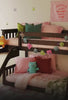 Kids in costumes playing in a room with a low loft bunk bed with slide, going down the slide, pouring candy down the slide.