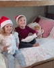 Kids playing in their bedrooms dressed up in holiday attire.