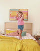 Kids playing and reading on different beds and bunk beds in bright, modern styled kids rooms. 